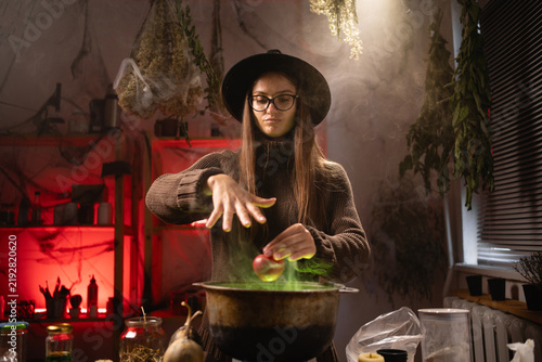 Bild auf Leinwand She holds a red apple, waves her hand, and recites a spell