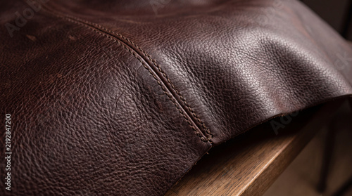 Vintage Leather Texture: Close-up shot of a weathered, brown leather surface, showcasing its unique grain and stitching, evoking a sense of history and craftsmanship.