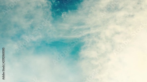 Soft Blue Sky with Wispy White Clouds Moving Across the Frame