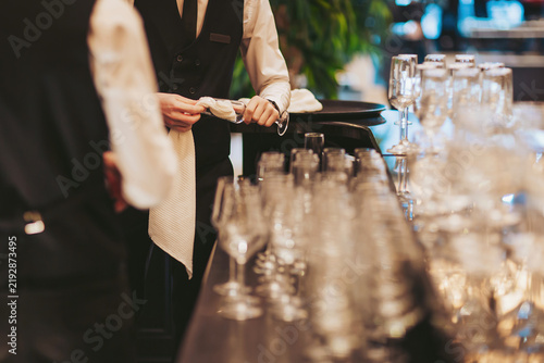 Busy waitstaff preparing for an elegant dining experience in a bustling restaurant setting