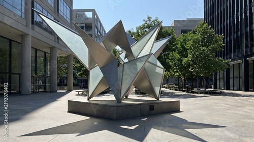 Modern geometric metal sculpture in urban plaza.