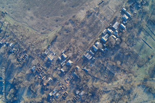 Aerial top view of ruined residential houses and private properties, damaged buildings and streets in disaster zone outdoors