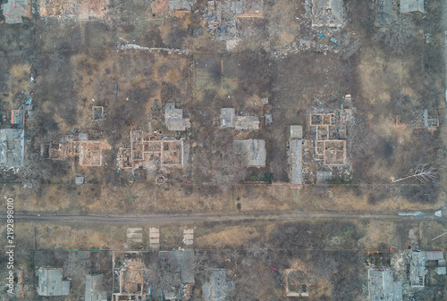 Aerial top view of ruined village houses and damaged countryside territory, destroyed private property outdoors