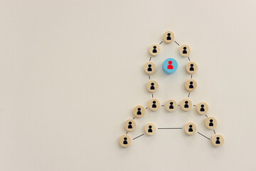 Wooden cubes with people icons forming rocket. Idea of leadership and teamwork
