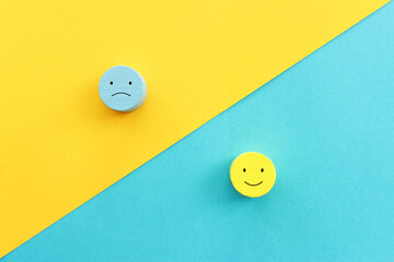 Top view image of wooden cubes with of happy and sad face. concept of happiness emotion and satisfaction