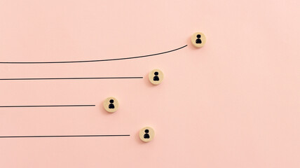 Wooden cubes with people icons over pastel background, human resources and management concept