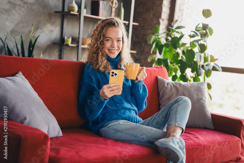 Foto Young woman enjoying a weekend at home with a cozy sweater, relaxing on a bright