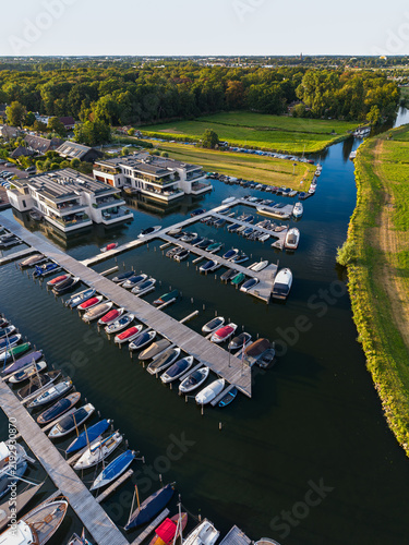 Photography High angle vertical aerial drone photograph of marina, floating wooden piers, mo