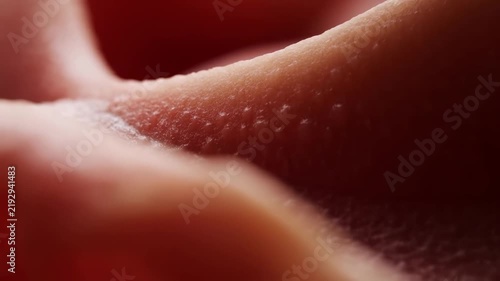 Human fingers press textured skin in an extreme macro close-up. Dermatology education, skincare advertising, and cosmetics campaigns.