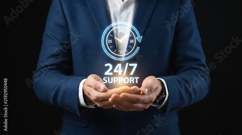 Businessman holding a glowing 24 7 customer support icon representing constant availability and professional service in business