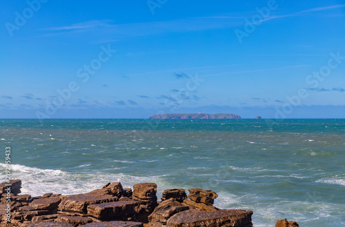 Waves crashing against coastal rocks