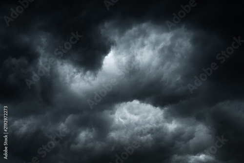 Bild auf Leinwand Against a backdrop of dark storm clouds
