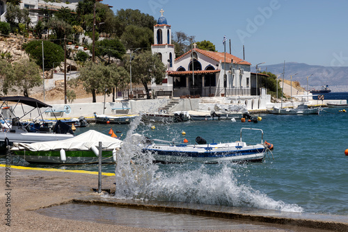 Quadro su tela On the embankment of Salamis Island (Greece) with a view of the church and the s