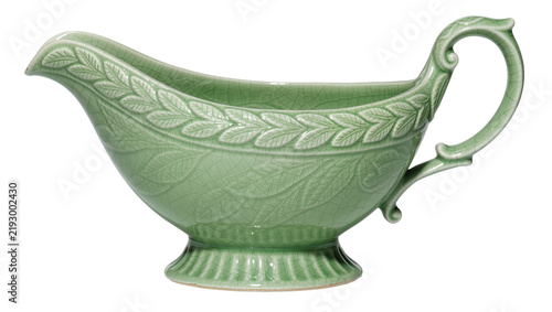 Green ceramic gravy boat with embossed leaf pattern, isolated on transparent background