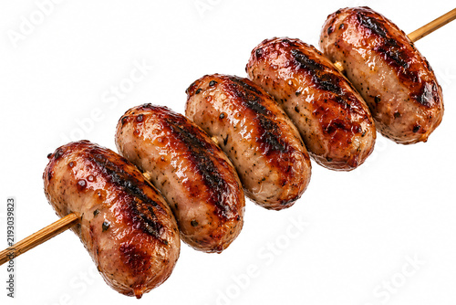 Juicy grilled sausages on a wooden skewer isolated on white