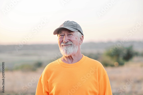 Quadro su tela Close portrait of elderly man showing natural skin texture and wrinkles, portrait of generation staying active and open