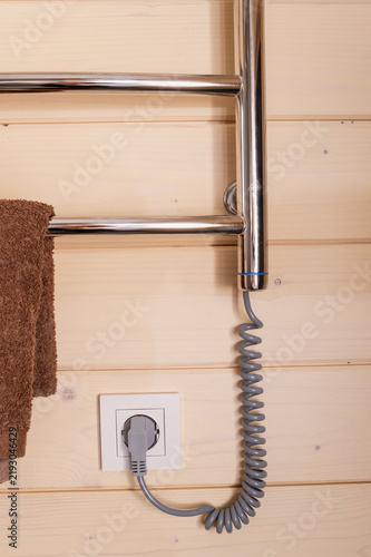 Energy-efficient electric towel warmer provides bathroom heating, dry towels, moisture control and convenient household living vertical