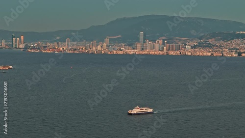 Aerial View of Passenger Ferry Cruising Izmir Bay with City Skyline at Sunset Turkey