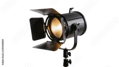 Konstfotografi Black Fresnel spotlight with barn doors emitting warm light, isolated on transpa