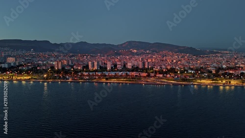 Aerial View of Bayrakli Coastline and Izmir Cityscape with Lights at Dusk Turkey