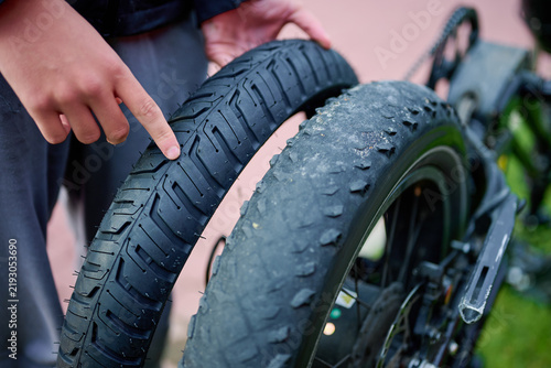 Man pointing at new road tire replacing old fatbike rubber