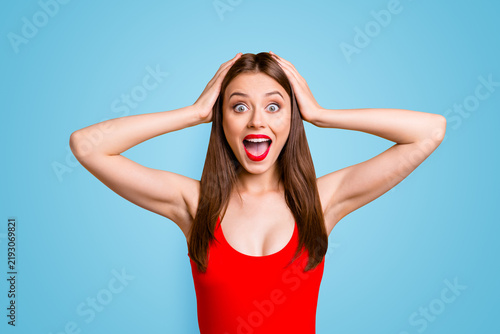 Obraz na plátne Close up portrait of  girl with a shocked face holds her head in her hands and c