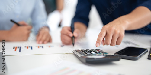 Cuadro en lienzo Close up hands of businessman financial advisor explaining financial result showing calculator to client or Colleague in meeting