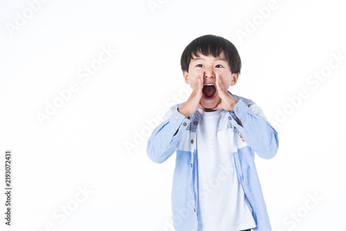 Young Boy Shouting with Hands Cupped Around Mouth on White Background