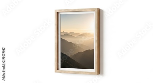 Framed landscape photo of mountain peaks on white wall.