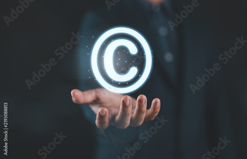 Konstfotografi Copyright protection concept with glowing copyright symbol in hands represent intellectual property rights, digital ownership, legal security, content protection, and safeguarding creative assets