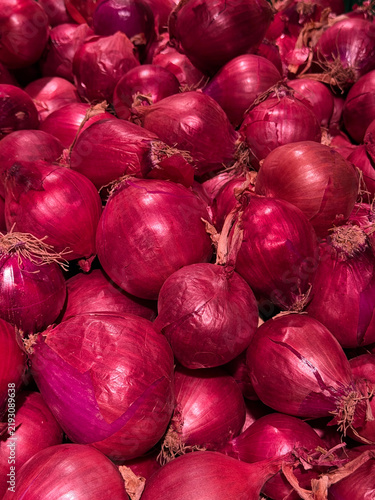 Red onions in market vertical