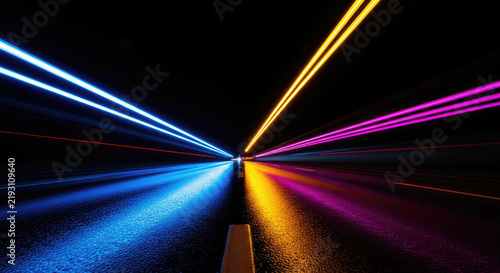 A long tunnel is illuminated by vibrant, streaking lights of blue, yellow, and pink. The lights create a dramatic effect, emphasizing the tunnel's depth and the road ahead.