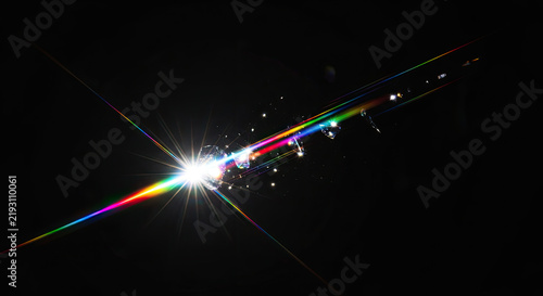 A bright, white light source explodes with a vibrant rainbow of colored light streaks.