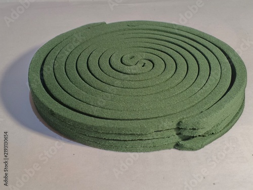Fotografie Stack of green mosquito repellent coils on white background