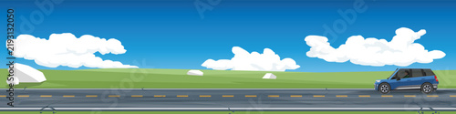 Horizontal of SUV car driving on asphalt road. Scenic highway road running through a green meadow landscape with a single car driving under a bright blue sky with white clouds. For banner background.