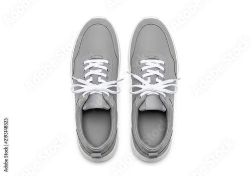 Pair of grey casual sneakers with white laces top view