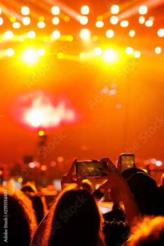 Concert crowd holding up smartphones at festival