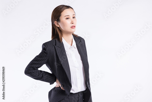 Foto Confident Asian Businesswoman in Pinstripe Suit Posing on White Background