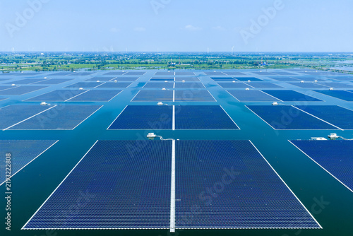 Aerial view of floating solar power photovoltaic panels on water surface