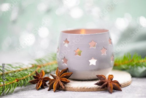 Foto Candle holder, tealight with stars and a burning candle light, winter christmas