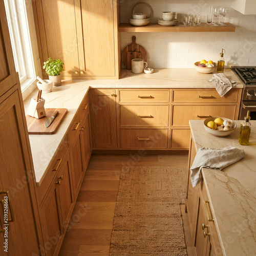 Warm wooden kitchen with a spice rack lemons and a jute rug underfoot in daylight