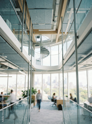 Interior view of a modern high rise office with a wide cityscape window
