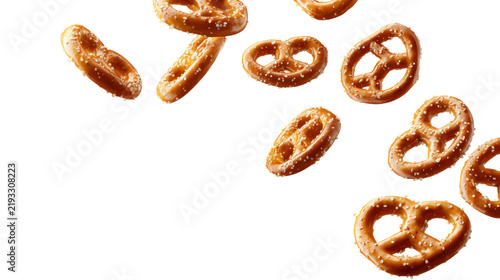 Salted pretzels falling in midair isolated cutout with motion blur and scattered snack pieces