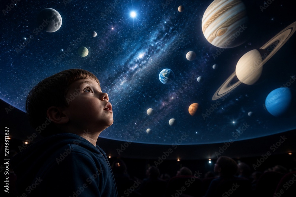 Fototapeta premium Boy gazing at planets in immersive planetarium dome