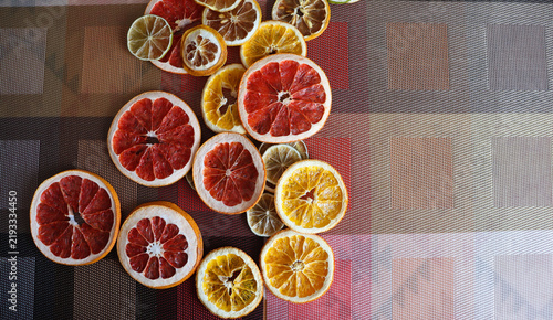 Sliced citrus fruits arranged on a textured surface, showcasing vibrant colors and unique shapes