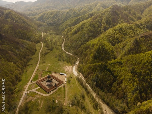 фотографія Scenic view of mountainous landscape in Romania, featuring winding river, lush g