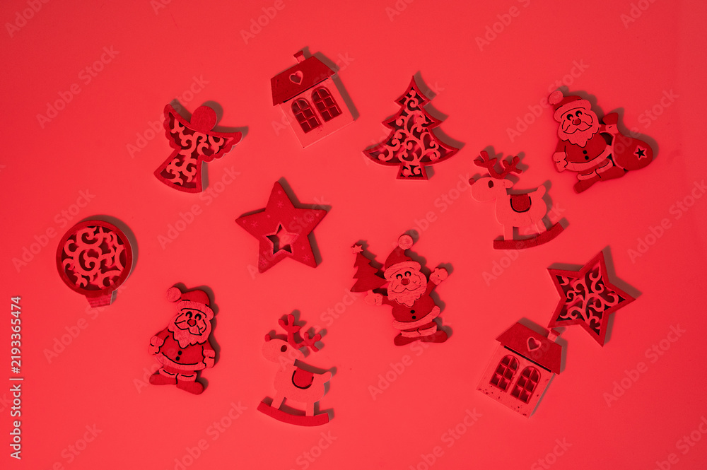 Fototapeta premium Christmas ornaments scattered on red background creating holiday pattern