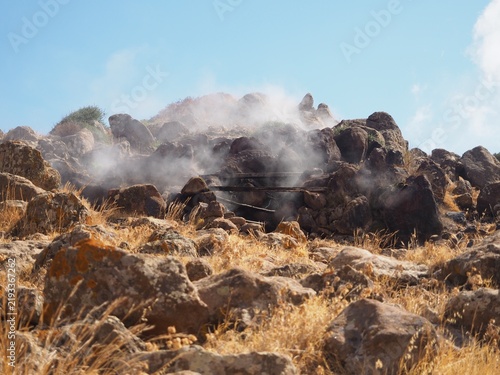 Steam rising from volcanic rocks at Favara Grande fumarole field in Pantelleria island