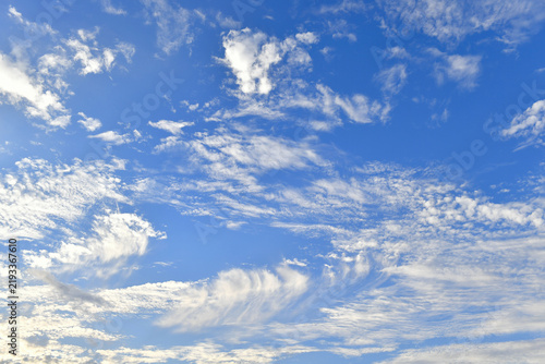 A blue sky with thin, wispy cirrus clouds, also known as feather clouds
