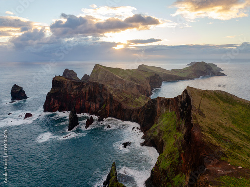 Aerial view of the rugged cliffs and dramatic coastline of Ponta de Sao Lourenco at sunset in Madeira, Portugal.